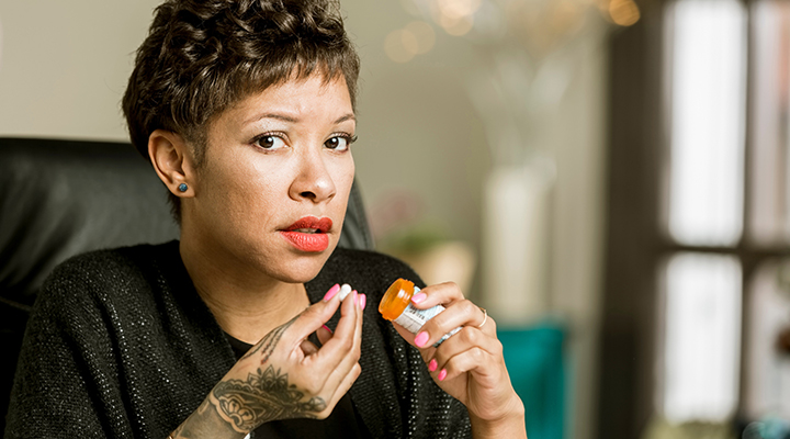 Woman holding pill bottle 