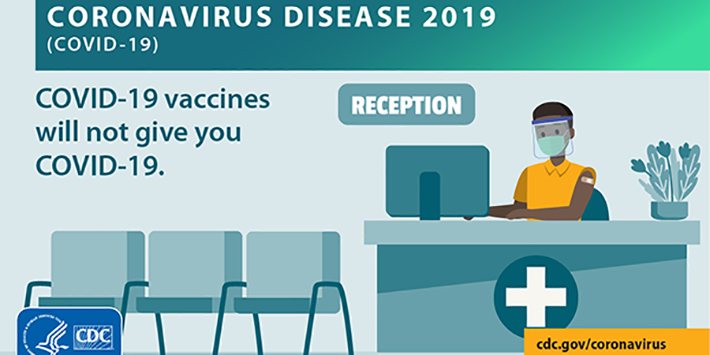 Reception sign and medic at desk of waiting room, Coronavirus (COVID-19) Disease 2019