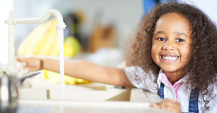 Girl turning on water