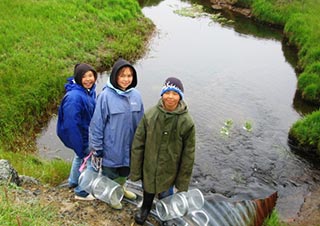 youth holding fish traps