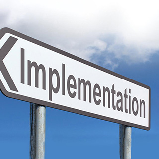 road sign that reads implementation