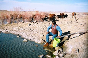 Man sitting beside lake