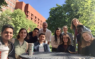 a group of people gathered outdoors posing for photo