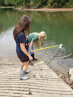 Community partners Nina McCoy and Debi Sexton conduct sampling activities.