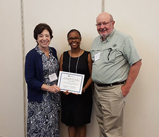 NIEHS and National Toxicology Program Director Linda Birnbaum, Ph.D., left, and HC-NCEH Director, Douglas Dockery, Sc.D., right, present James-Todd with a certificate for her poster presentation