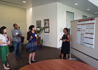 James-Todd presents her poster to an engaged audience at the Environmental Health Sciences Core Centers’ meeting, held July 2018 in Davis, California