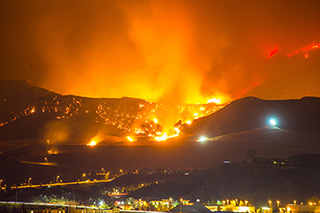 Wildfire during night near a city
