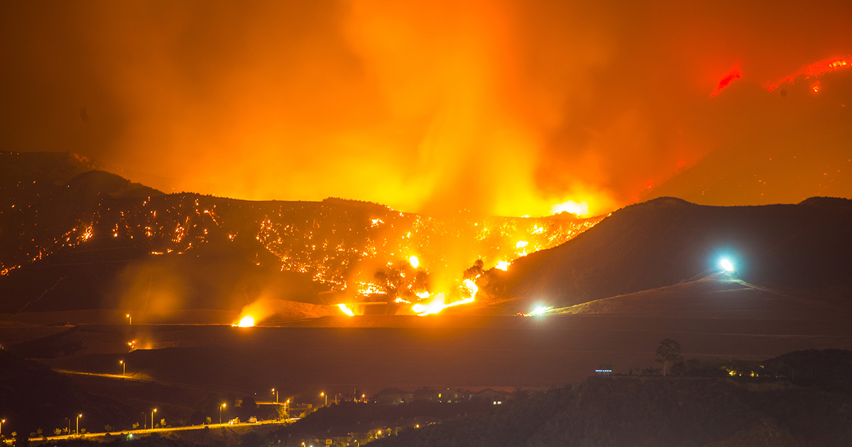 Wildfire during night near a city 