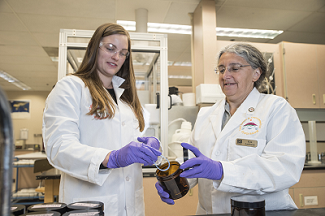 Kim Anderson and Holly Dixon in the lab prepping a wristband for analysis