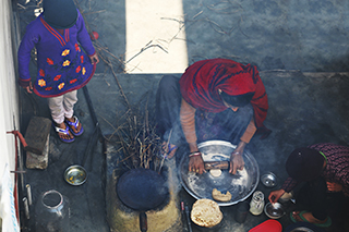 women using a cookstove in India