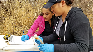 Yoshi Ornelas Van Horne and Mariah Paul sampling water