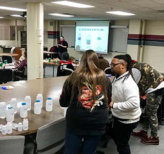 Carrera's team work with contaminated water with residents in Flint, Michigan.