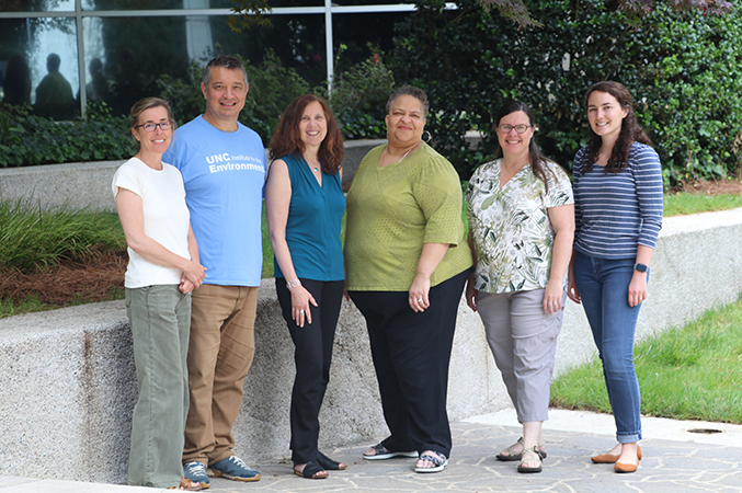 group of researchers posing for photo outside the University of NC Chapel Hill