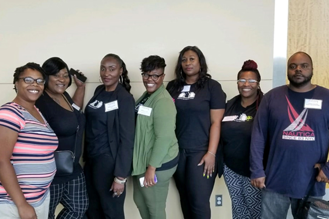 a group of volunteers and educators posing for photo