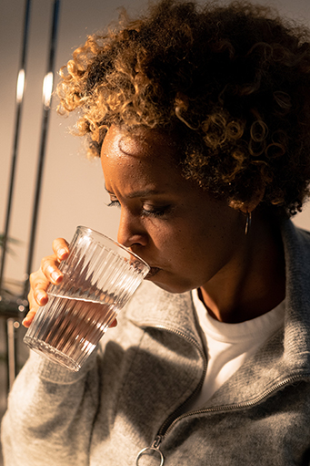 woman drinking a glass of water