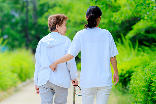 younger woman walking with an older woman