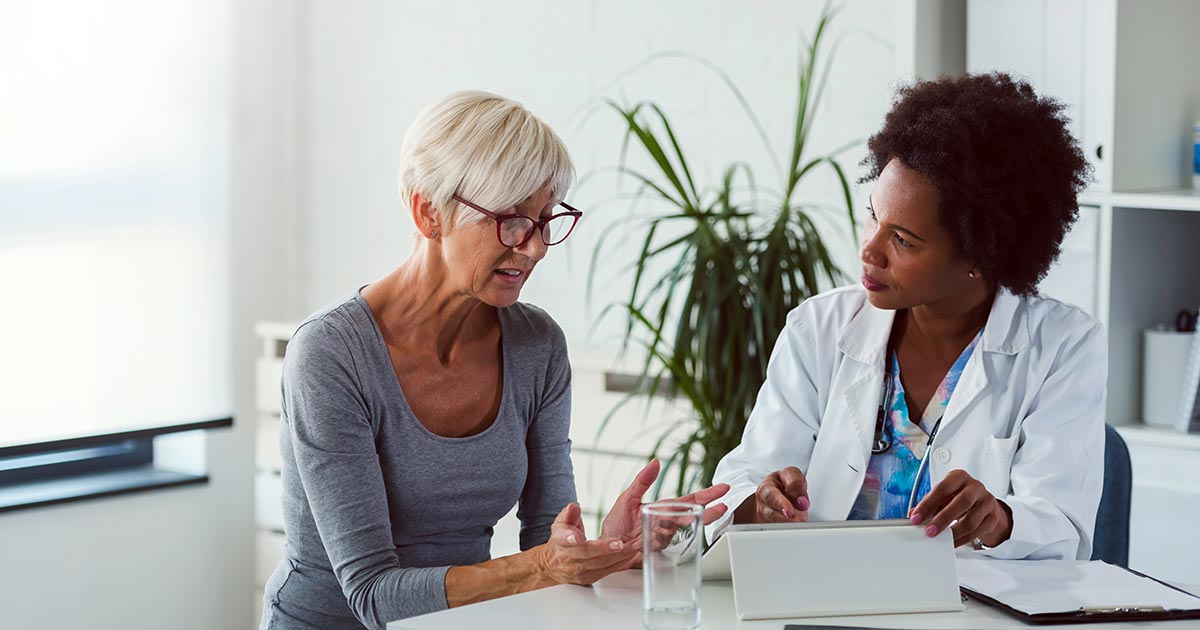 female doctor with elderly female patient