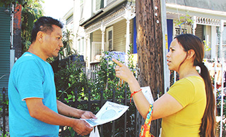 Male and female standing in the street talking about community planning