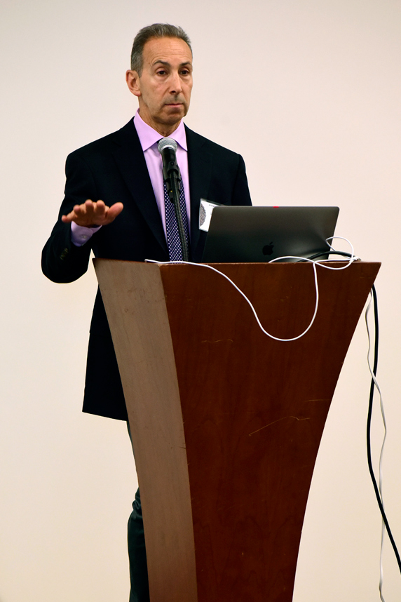 Darryl Zeldin, M.D. stands at podium