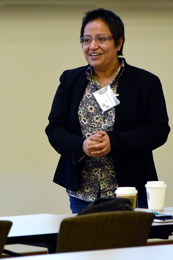 Priyamvada Acharya, Ph.D. smiles at audience