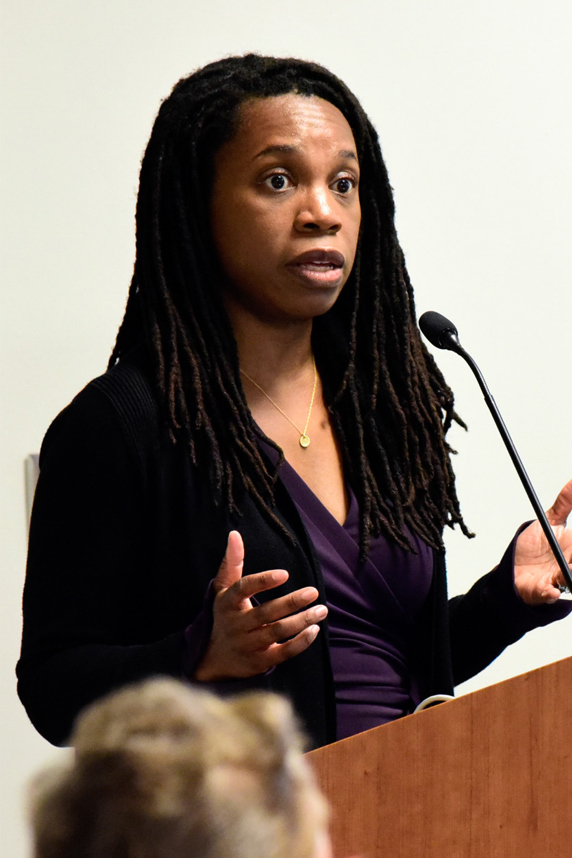 Oluwadamilola "Lola" Fayanju, M.D. stands at podium