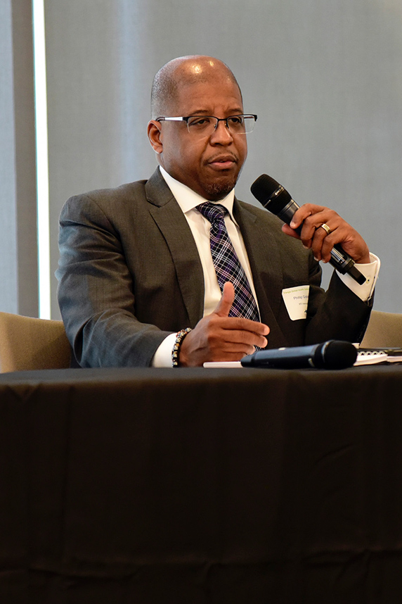 Phillip Graham, Dr.P.H., from RTI, holds microphone