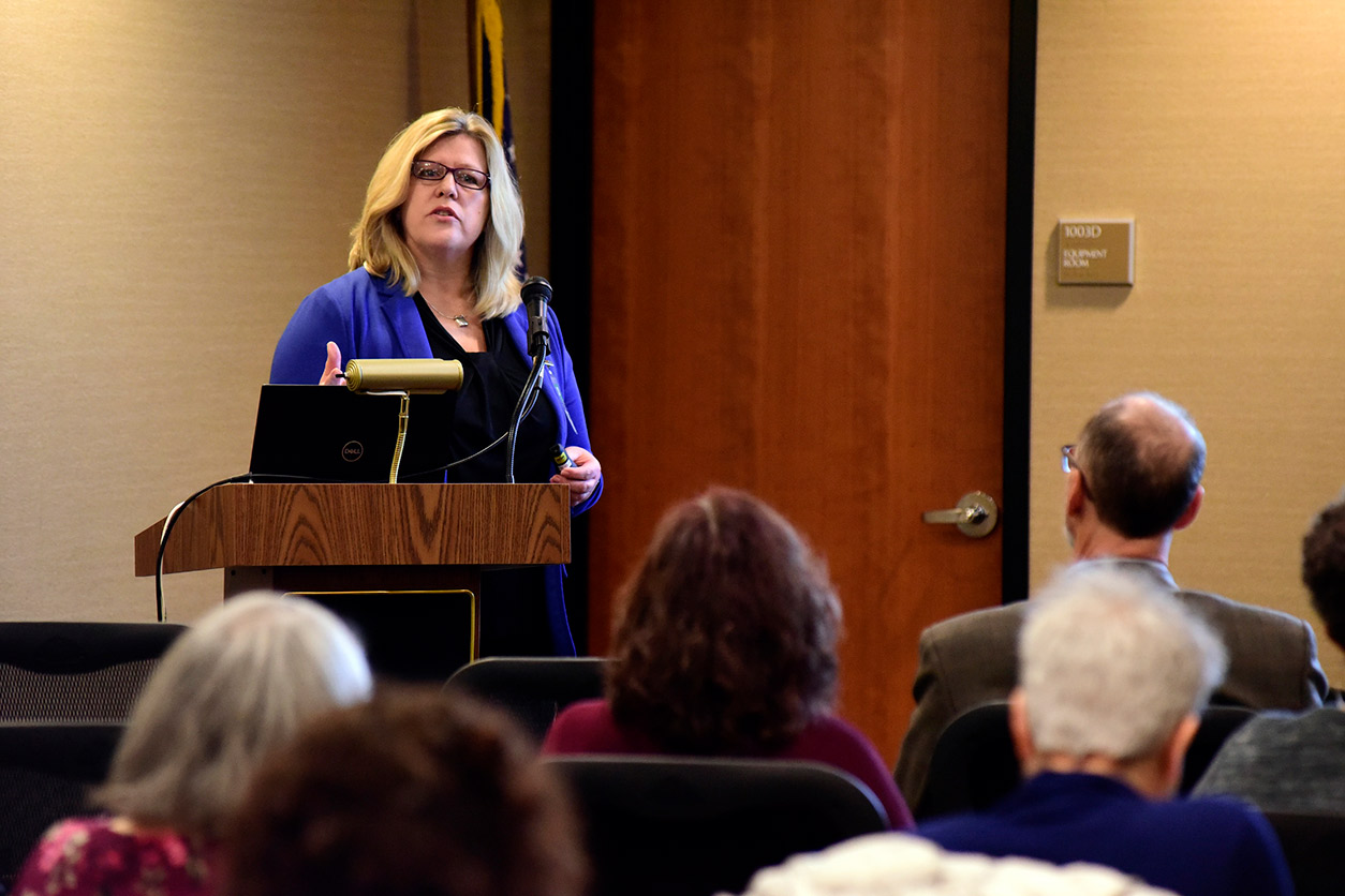 Kami Silk, Ph.D. stands and speaks to an audience