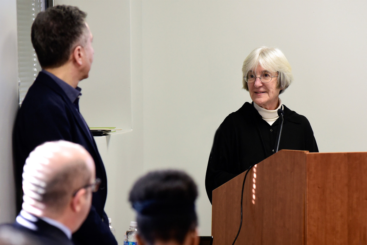 Donna Baird, Ph.D. at podium, and audience shown in foreground