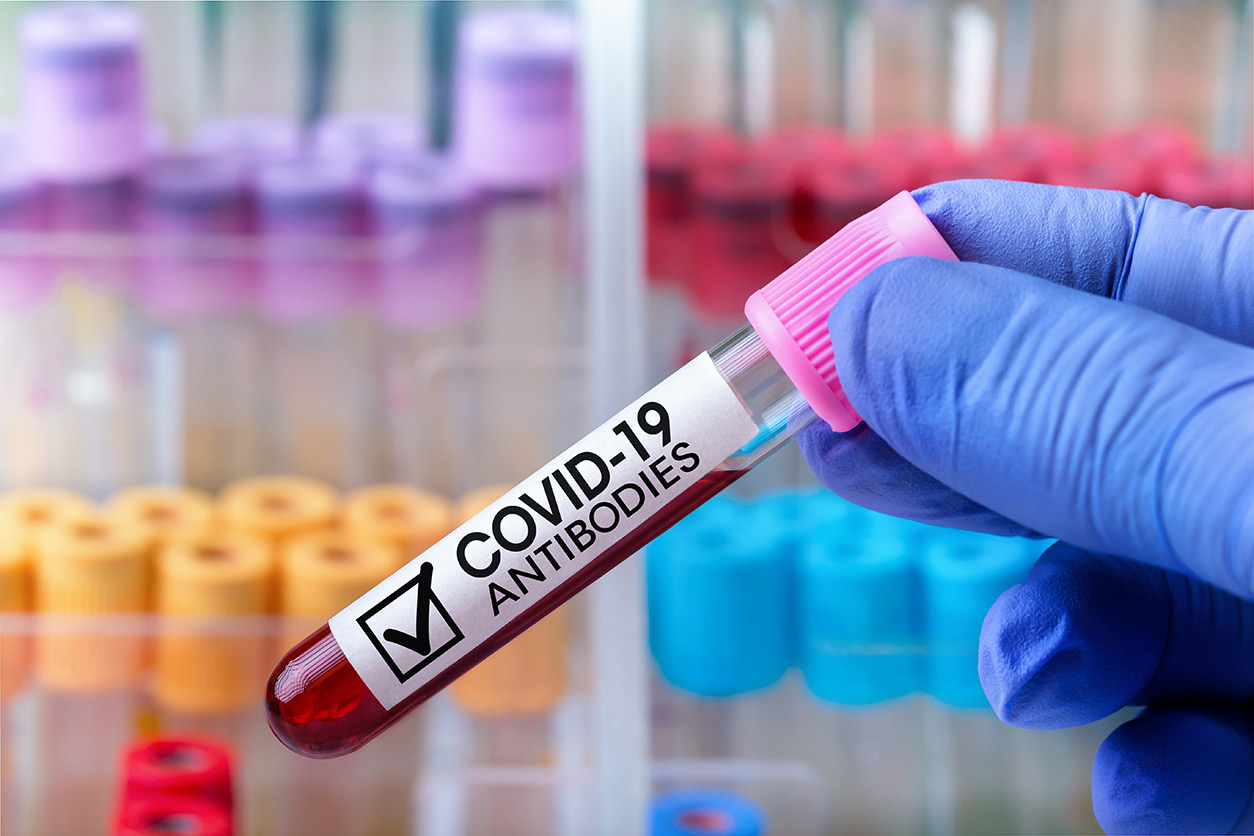 hand holding COVID-19 blood antibodies in a tube