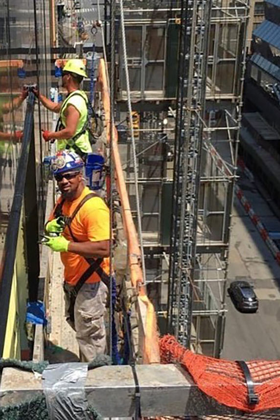 The BuildingWorks graduate and another worker at the job site