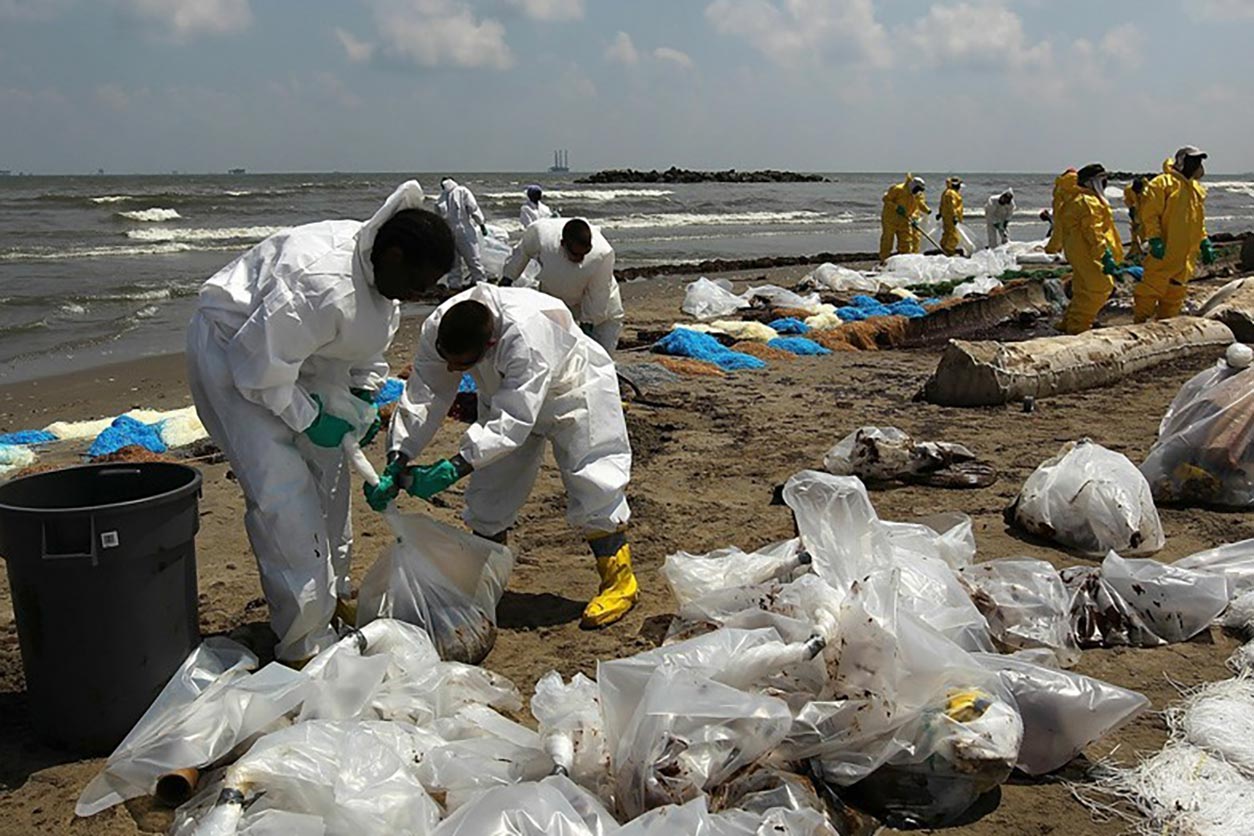 ECWTP participants in protective gear helps clean up the beach
