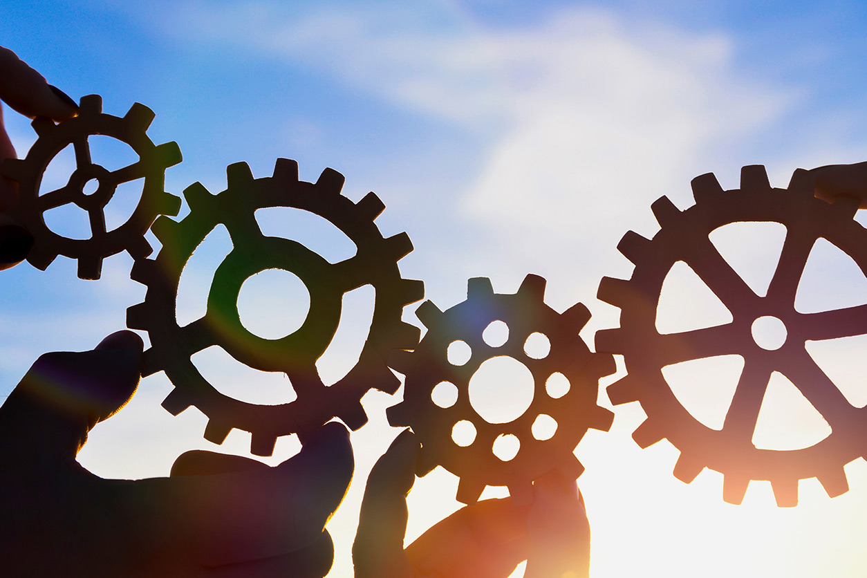 hands connect gears like a puzzle