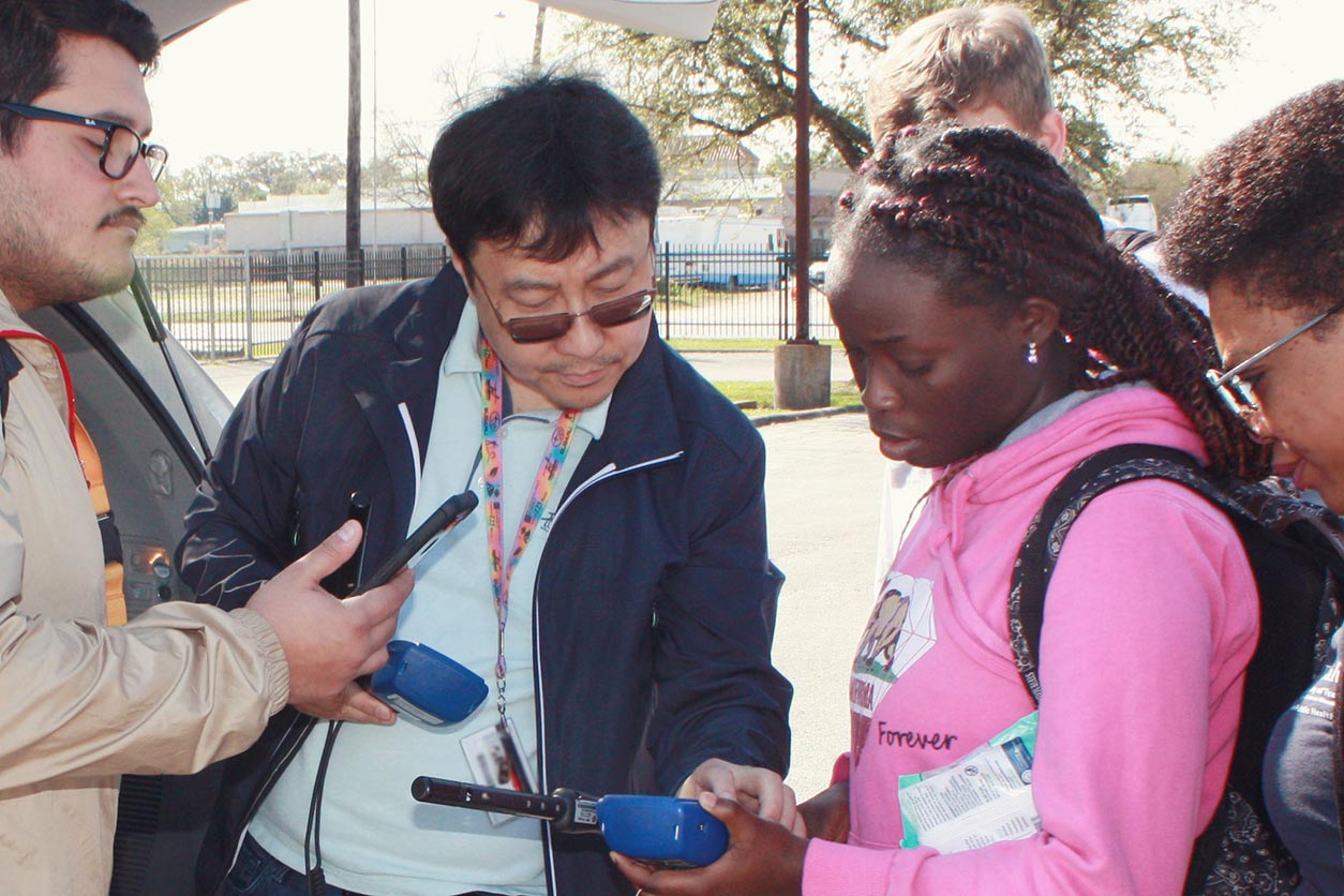 Inkyu Han talks with the field team