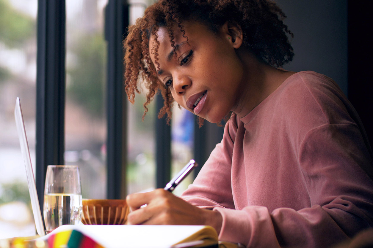 woman sitting and writing
