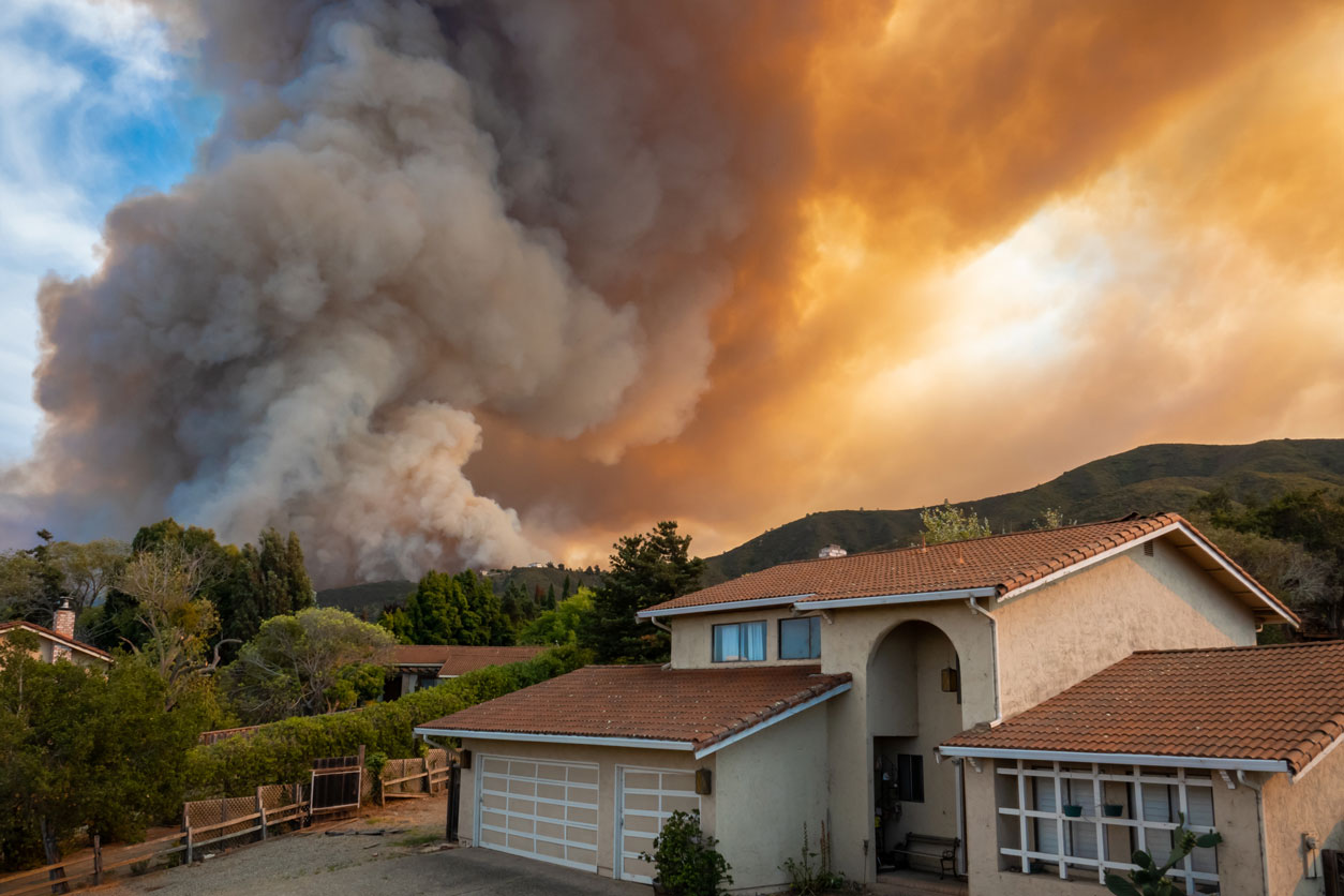 wildfire behind a home