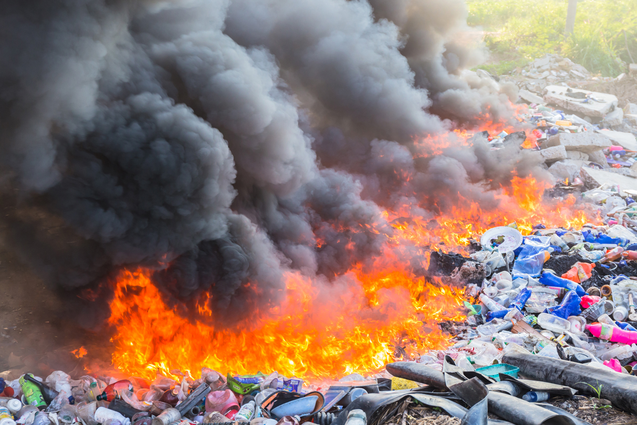 Plastic on the ground on fire with black smoke